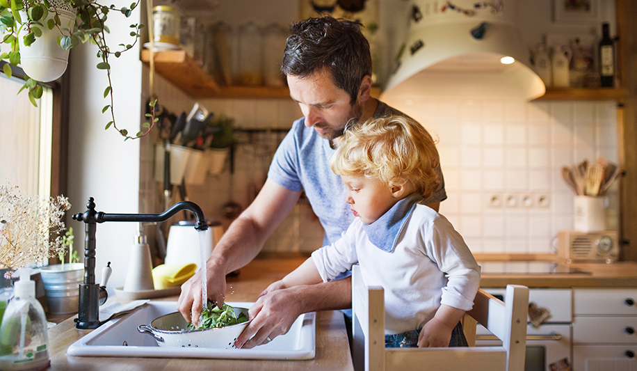 Father and son cleaning vegetables in a clean house that uses Thymox, a non-toxic botanical disinfectant